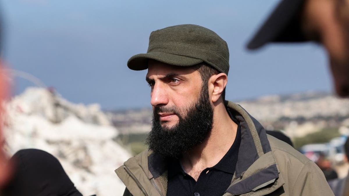 Hayat Tahrir al-Sham (HTS) jihadist group's chief Abu Mohamed al-Jolani checks the damage following an earthquake in the village of Besnaya in Syria's rebel-held northwestern Idlib province at the border with Turkey, on February 7, 2023.