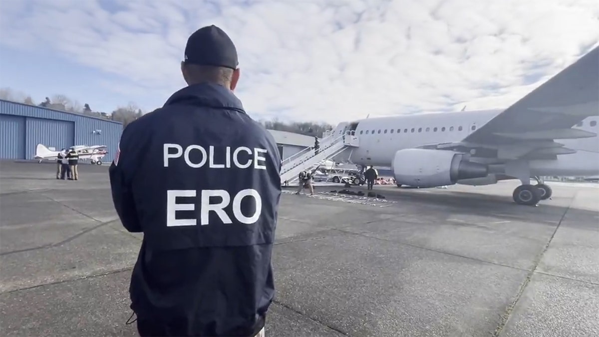 man in police jacket on airport tarmac