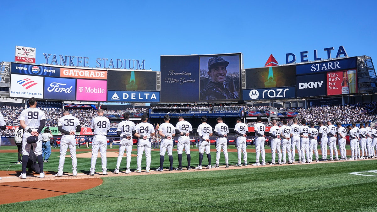 A moment of silence is observed for Miller Gardner, son of former New York Yankees player Brett Gardner, before the start of an opening-day baseball game between the Yankees and the Milwaukee Brewers at Yankee Stadium, Thursday, March 27, 2025, in New York.