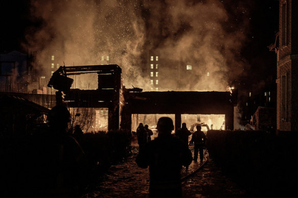 A house is engulfed in flames from a reported Russian drone strike in Kyiv last month. 