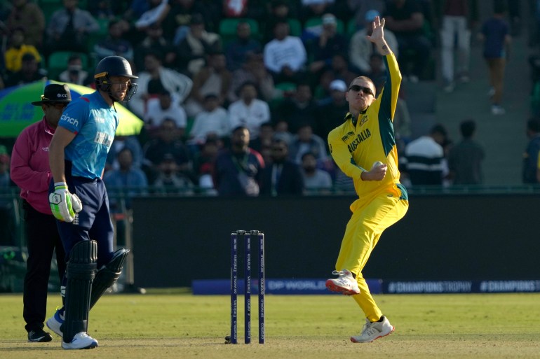 Australia's Adam Zampa, right, bowls as England's Jos Buttler watches during the ICC Champions Trophy cricket match between Australia and England, in Lahore, Pakistan, Saturday, Feb. 22, 2025. (AP Photo/K.M. Chaudary)