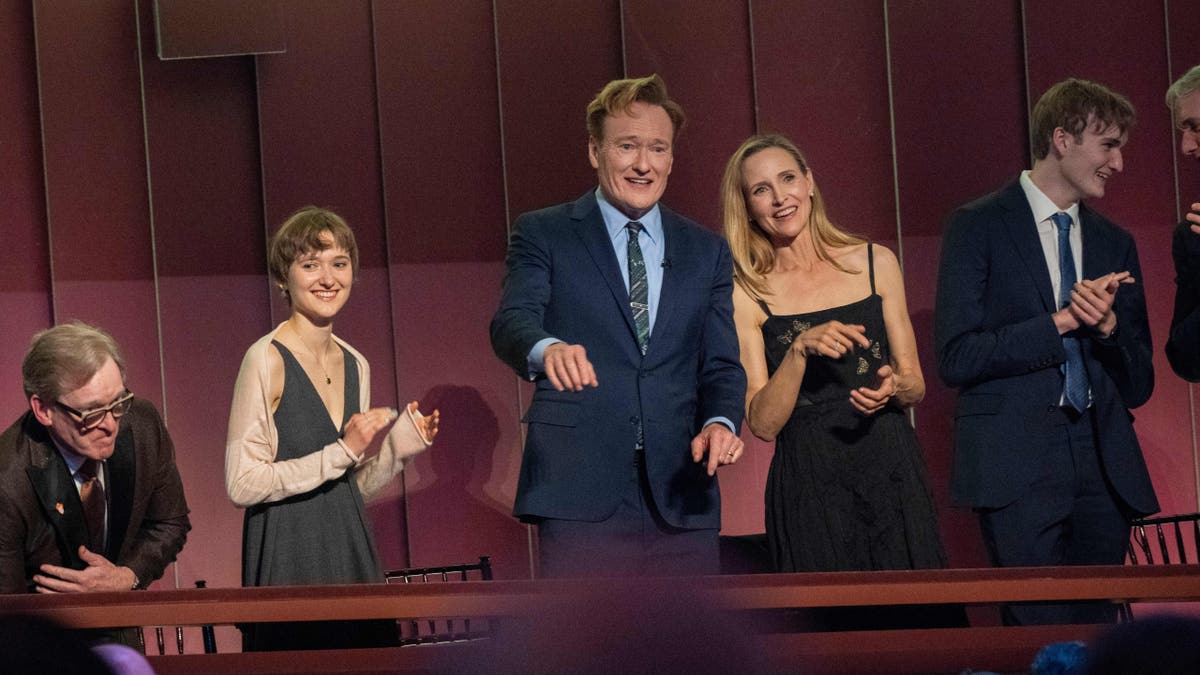 Comedian Conan O'Brien, center, and his wife, Liza Powel O'Brien, look out on the crowd at the start of the 25th Annual Mark Twain Prize for American Humor Celebrating Conan O'Brien. 