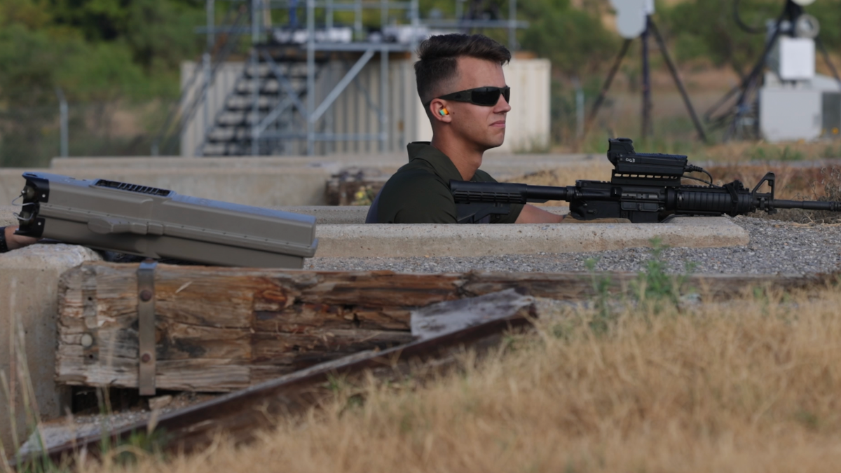 Trainee points Smart Shooter Fire Control Optic at target