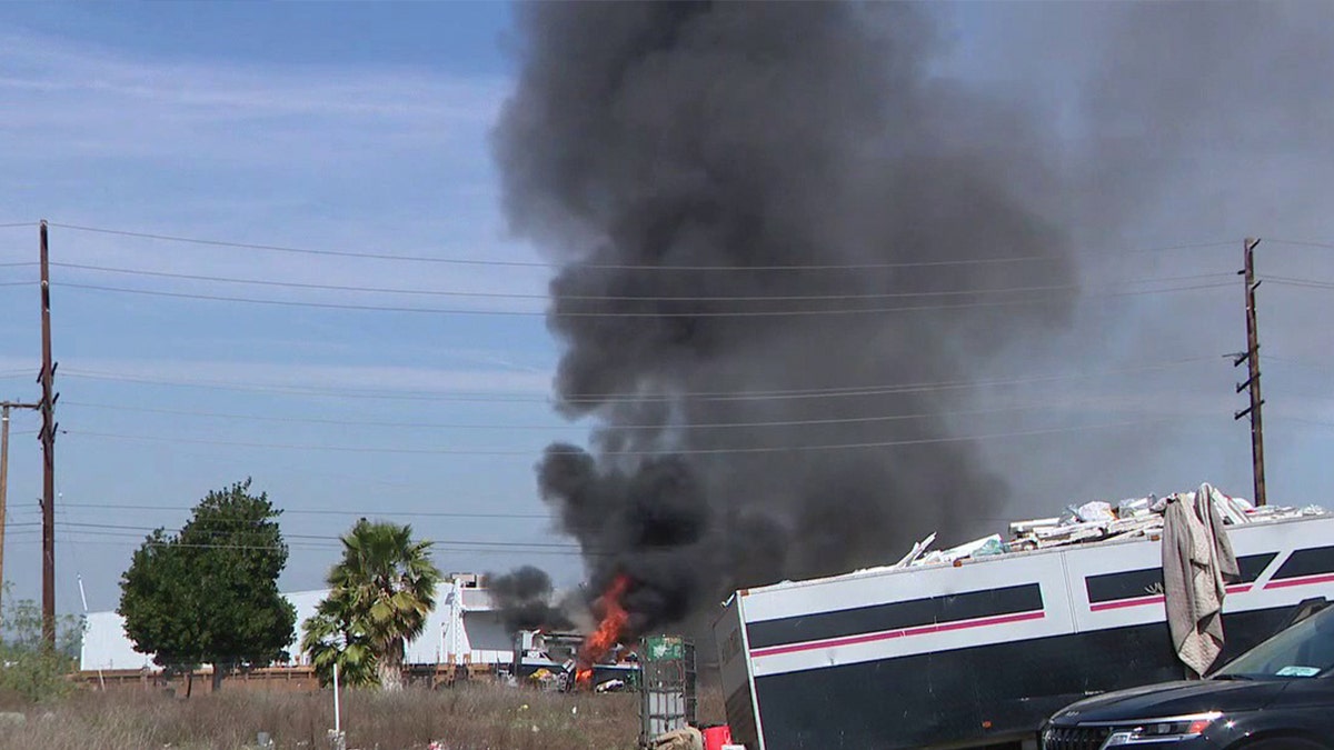 smoke billows from RV fire