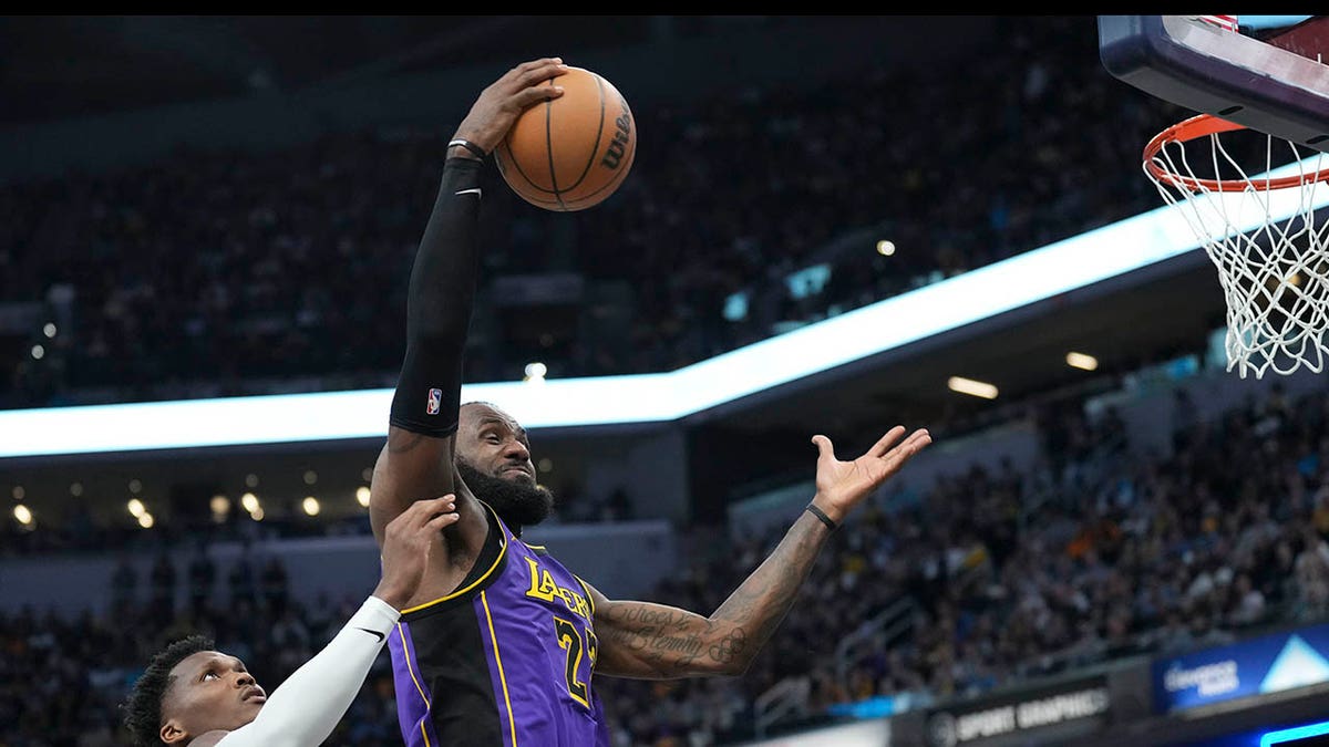 LeBron James rebounds the ball