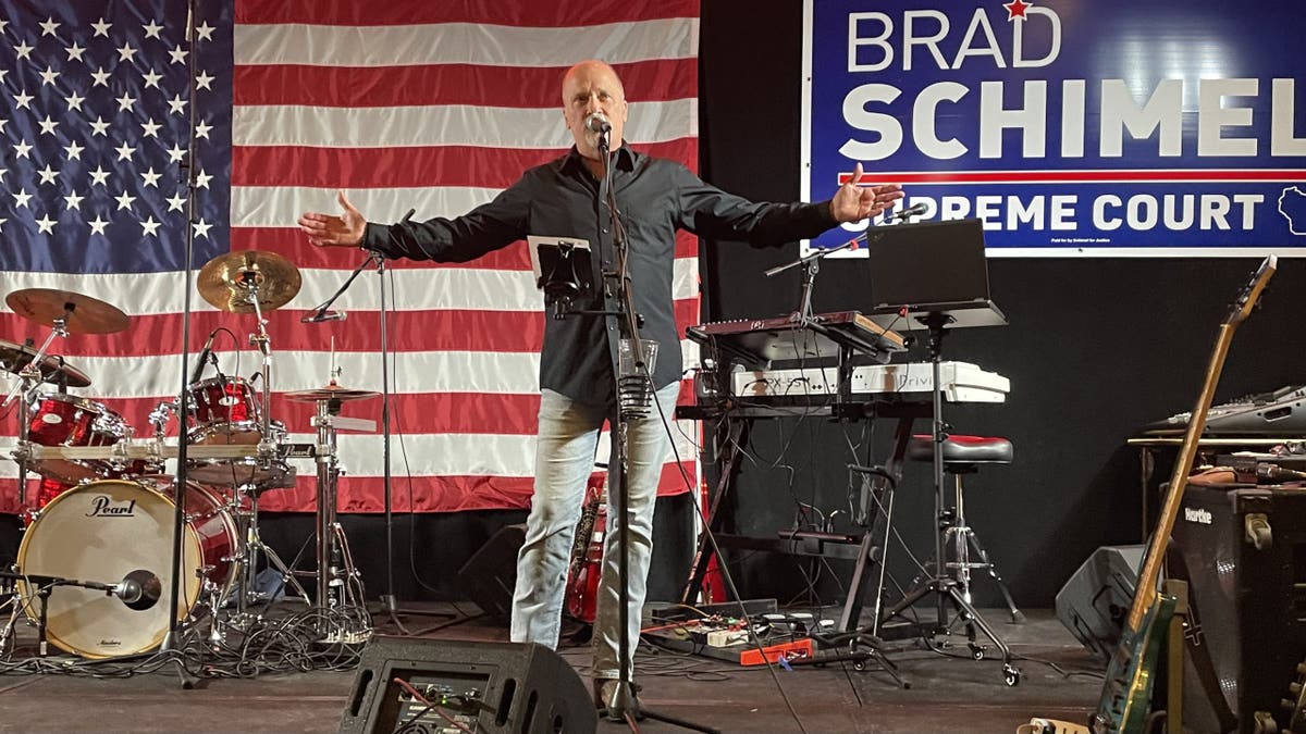 Brad Schimel on stage, US flag behind him
