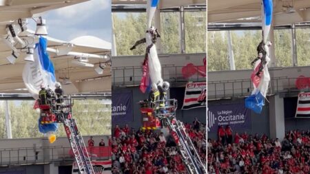 Rugby fans hold their breath as firemen rescue dangling parachutist