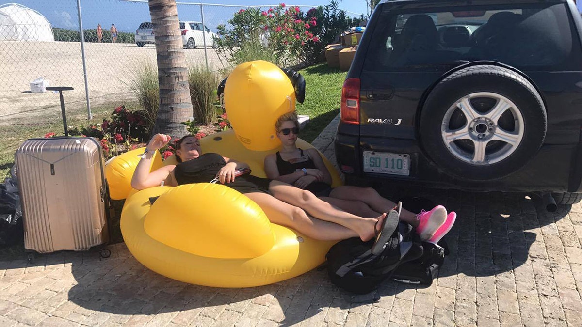 Two women lay on an inflatable ducky at Fyre Festival