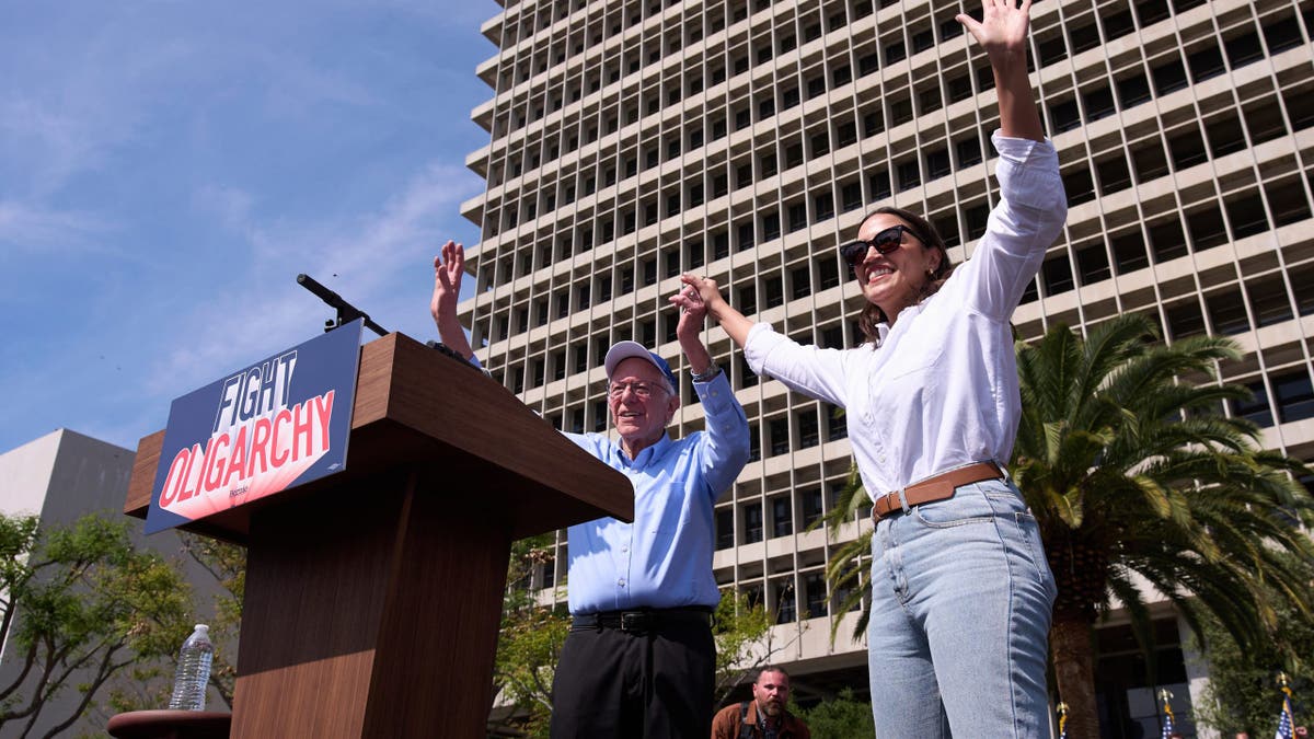 Sanders and AOC waving to the crowd