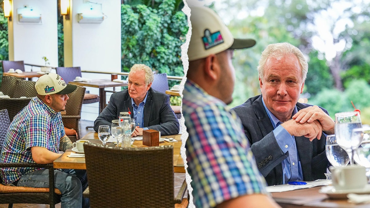 Sen. Chris Van Hollen seated across from Kilmar Abrego Garcia at an outdoor table in El Salvador, with glasses of water and what appear to be margaritas in front of them.