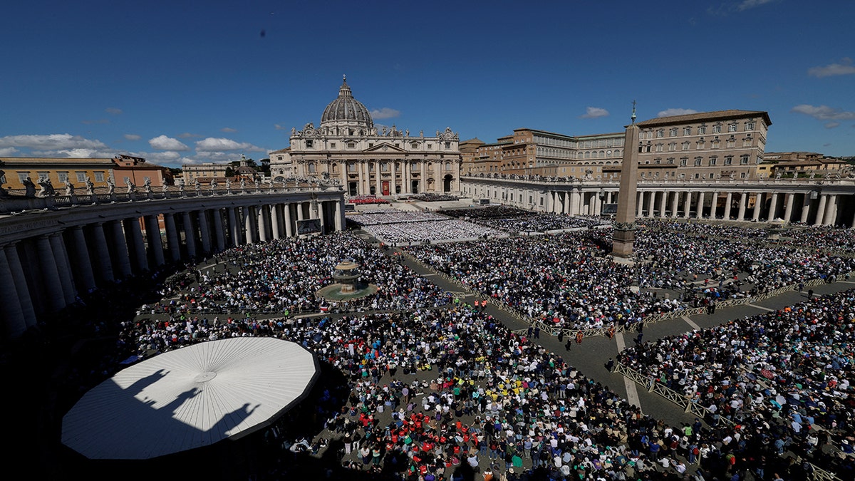 St. Peter's Basilica with mourners in front of it