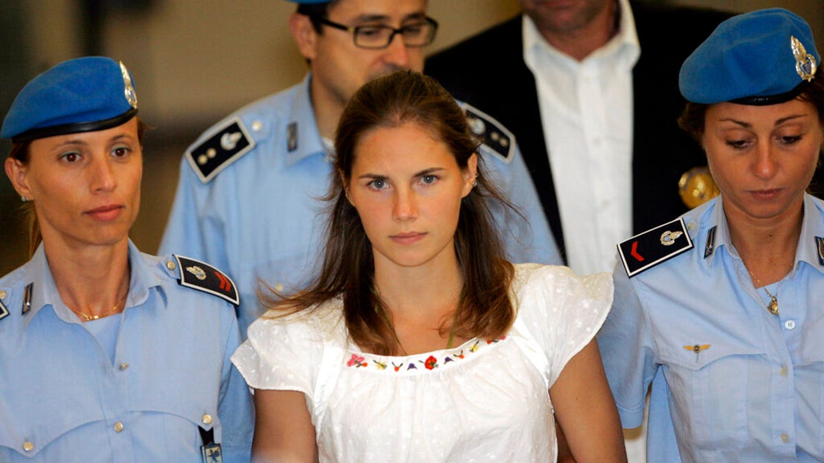 Amanda Knox escorted by Italian police officers in 2015