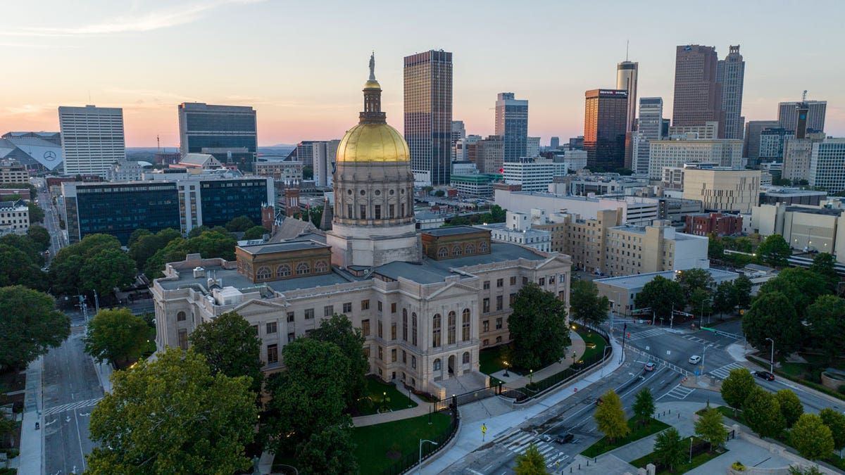 Georgia Capitol with atlanta skyline behind it
