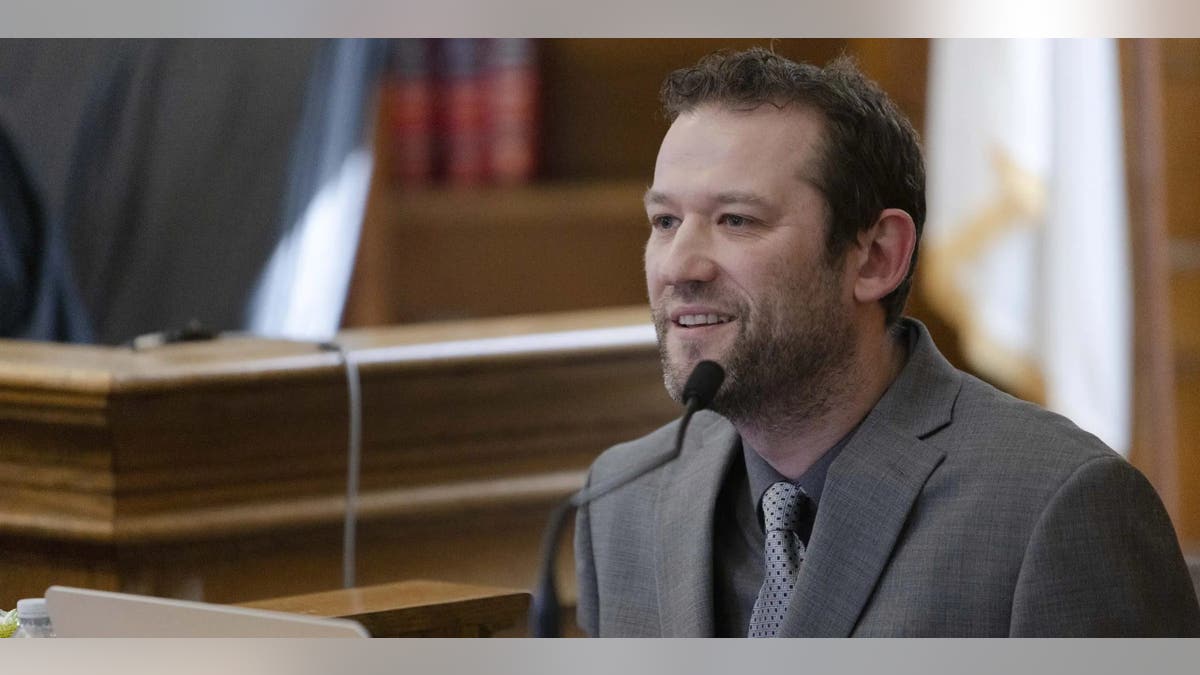 Ian Whiffin wearing a gray suit on the witness stand