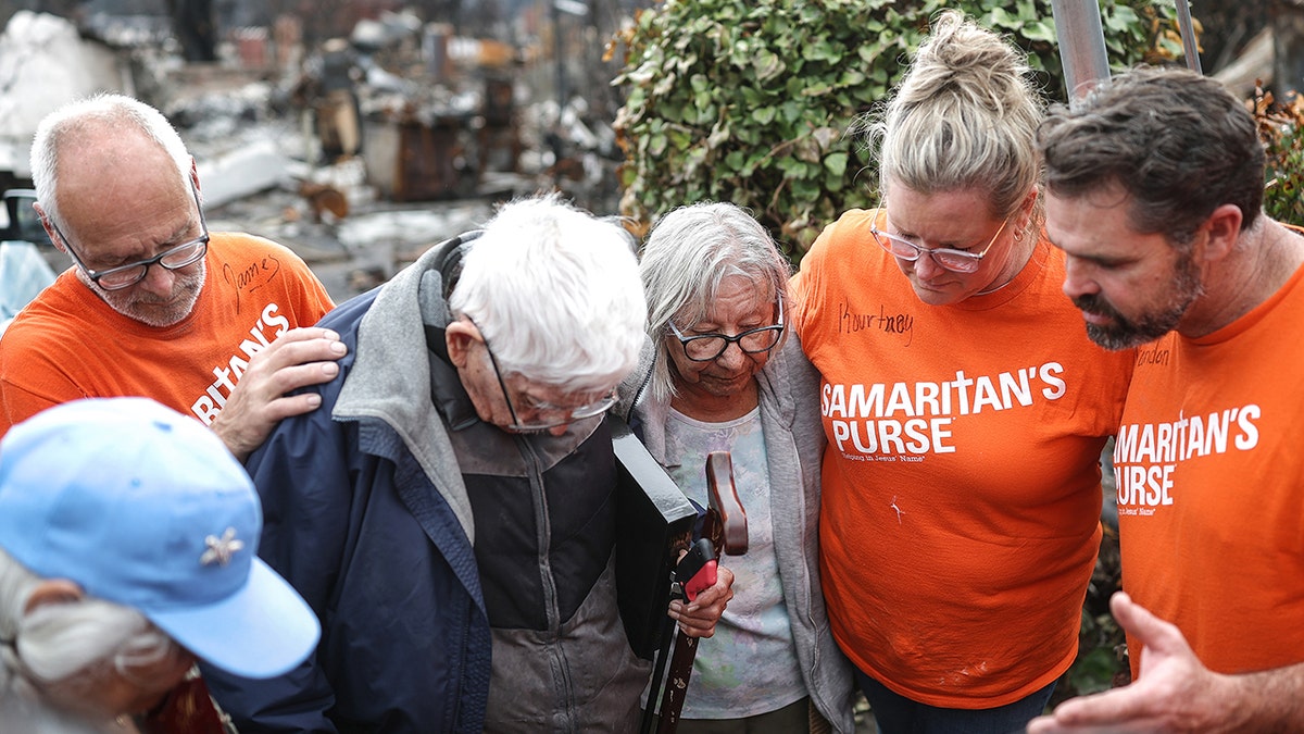 Volunteers with Samaritan's Purse pray with Manuel and his wife Emma Alvarado