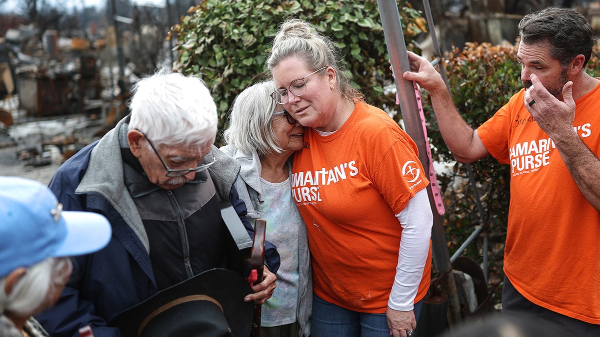 Volunteers with Samaritan's Purse pray with Manuel and his wife Emma Alvarado