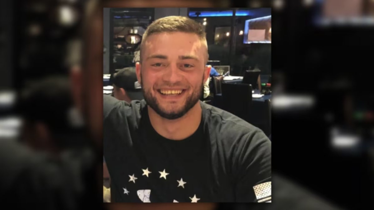 Connor Floyd smiling and wearing a black shirt