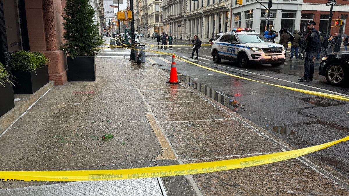 A broken glass bottle on a SoHo sidewalk at the April 7 stabbing scene
