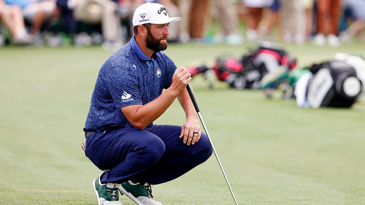 Jon Rahm lines up his putt