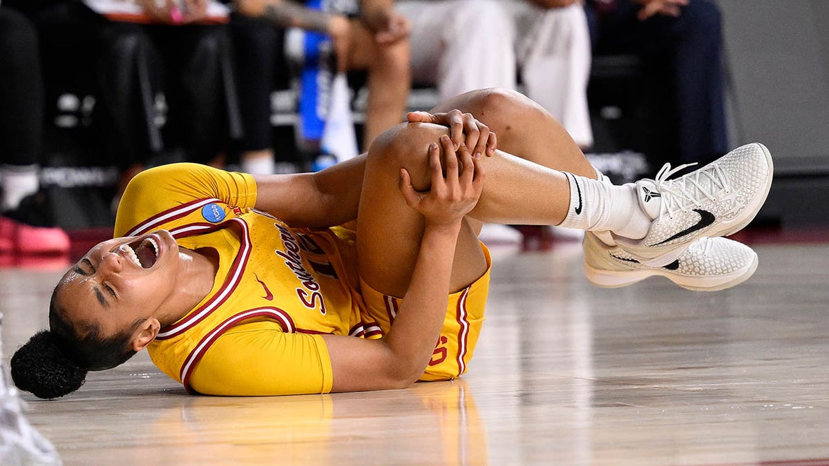JuJu Watkins grabs her knee