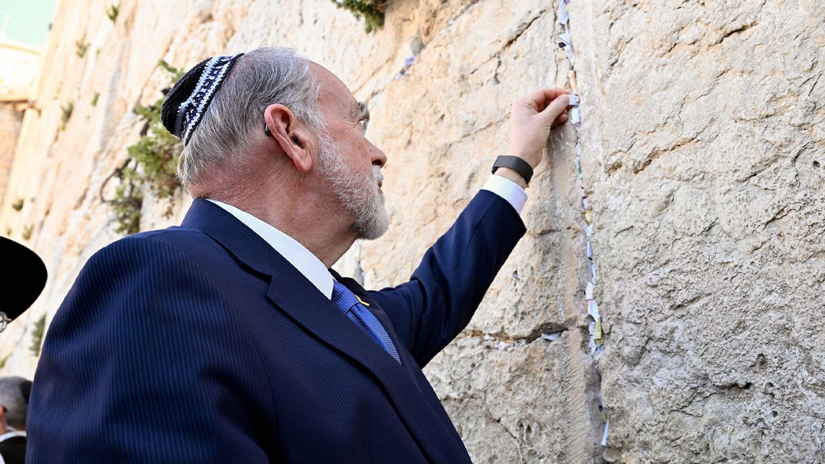 U.S. Ambassador to Israel Mike Huckabee places a note in the Western Wall