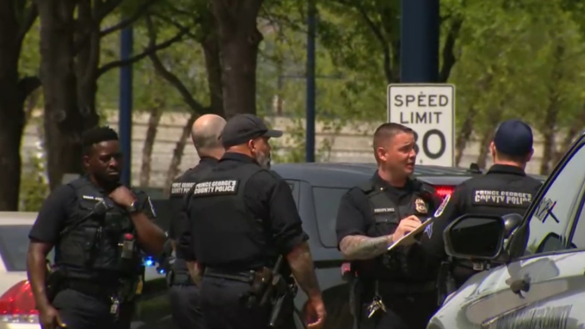 police gather and talke near vehicles