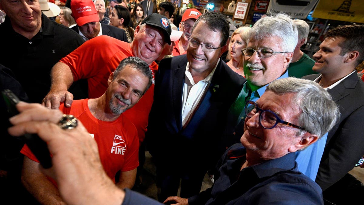 Republican Randy Fine, center, meets with supporters after the special election for U.S. House District 6 was called in his favor, Tuesday, April 1, 2025 in Ormond Beach, Fla. (AP Photo/Phelan M. Ebenhack)
