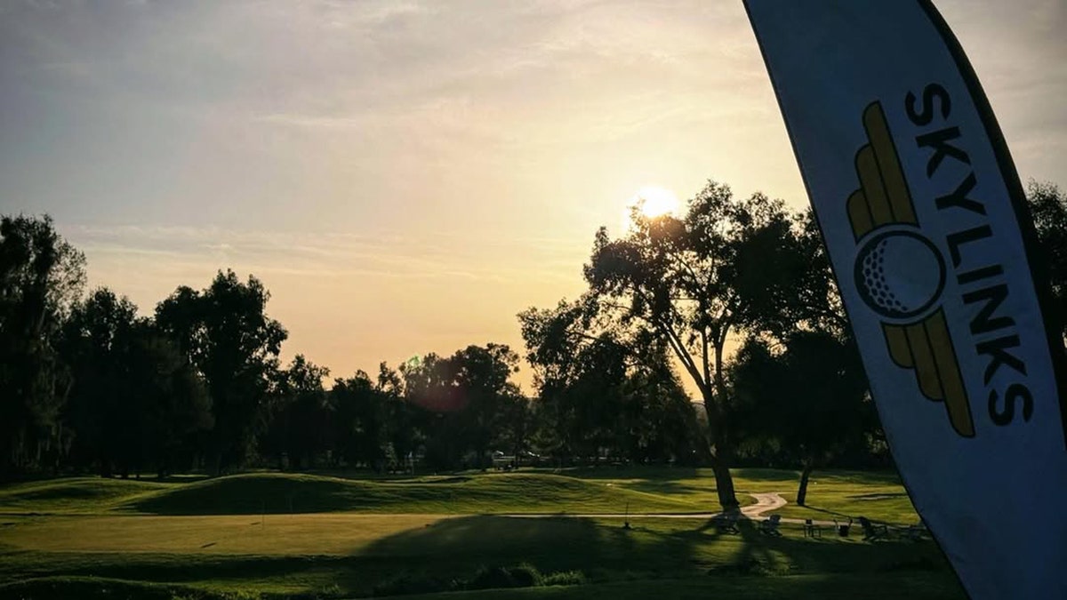 Sunrise over Skylinks Golf Course in Concord, California, with a Skylinks banner in the foreground and trees lining the course