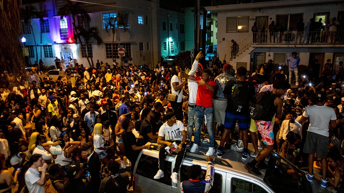 Crowds gather in the streets of Miami Beach