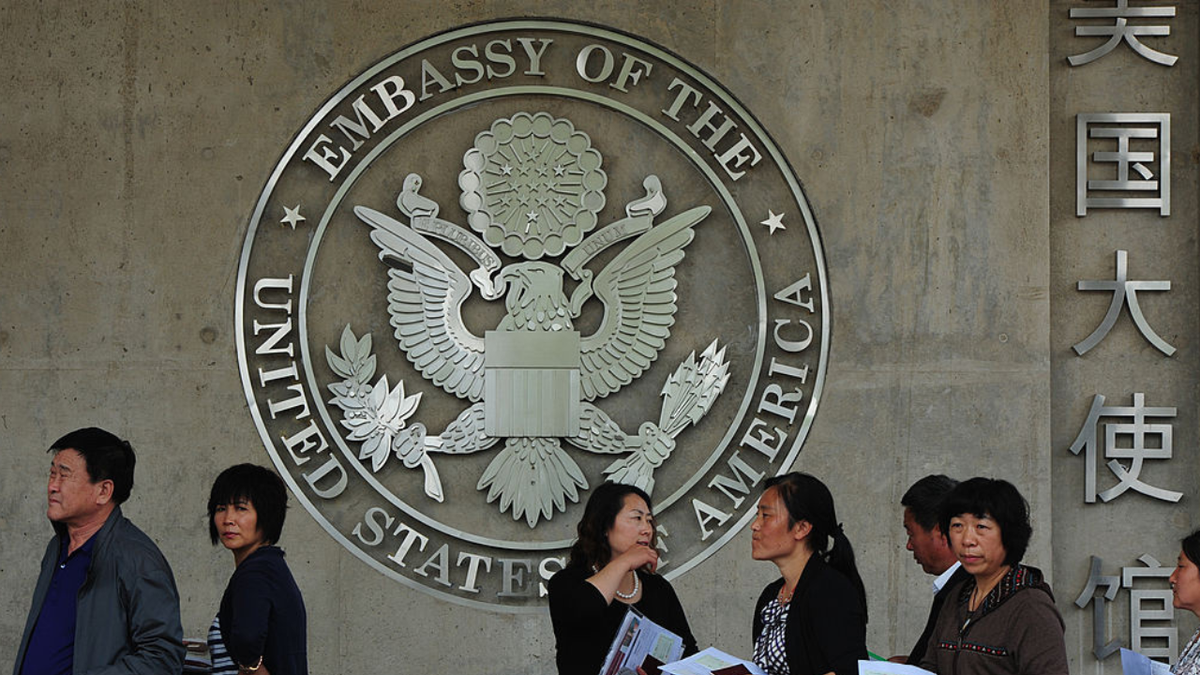 Chinese citizens are seen at the U.S. Embassy in Beijing waiting to submit their visa applications.