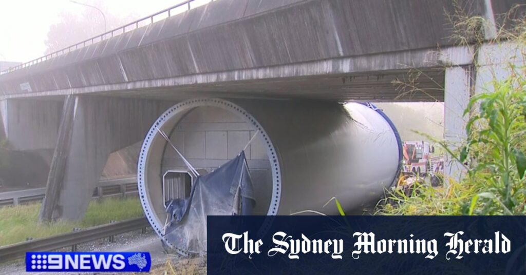Truck carrying wind turbine smashes into bridge