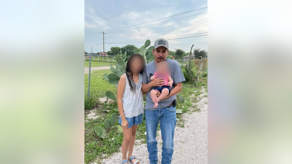 Aaron Martinez poses with his two children