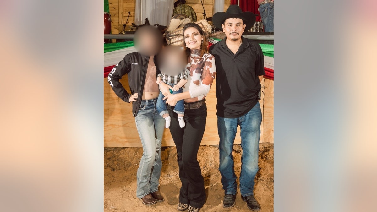 Aaron Martinez poses with his wife and two children