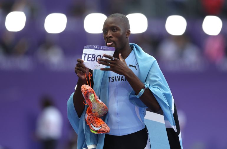 PARIS, FRANCE - AUGUST 08: Letsile Tebogo of Team Botswana celebrates winning the gold medal after competing in the Men's 200m Final on day thirteen of the Olympic Games Paris 2024 at Stade de France on August 08, 2024 in Paris, France. (Photo by Julian Finney/Getty Images)