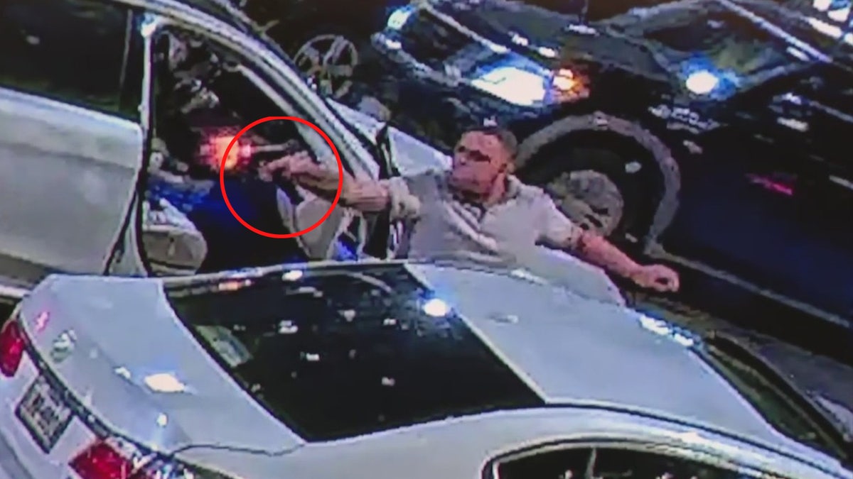 Kendrick Finch pulling out a gun