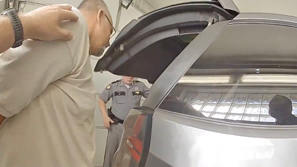 Mickey stines peers into police cruiser