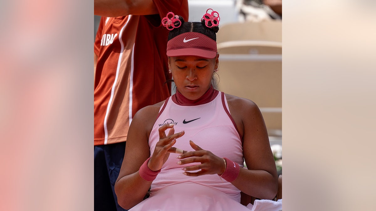 Naomi Osaka clips her nails