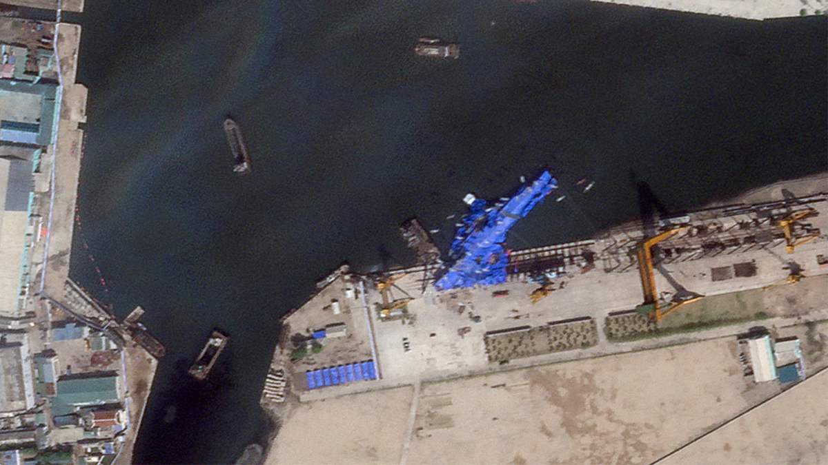 North Korean warship covered with a blue tarp