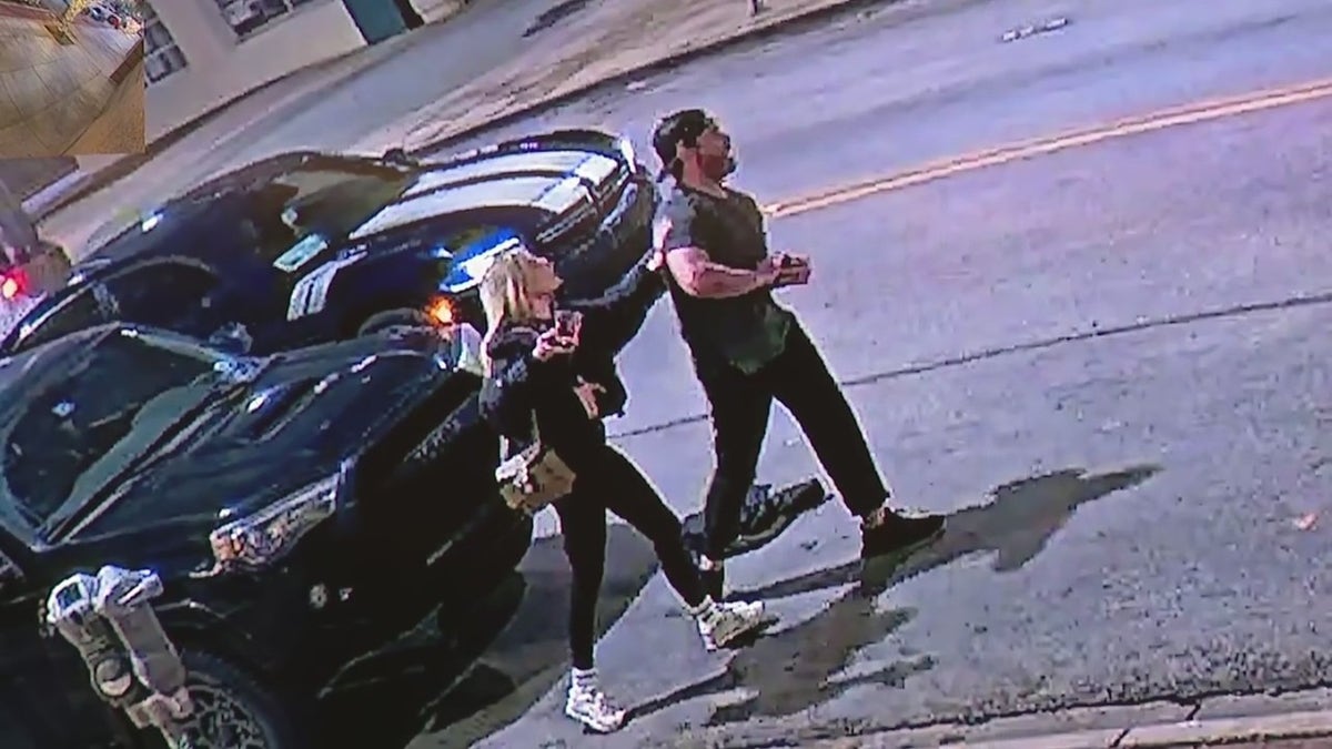 Ashlee Long and a unnamed man crossing the street