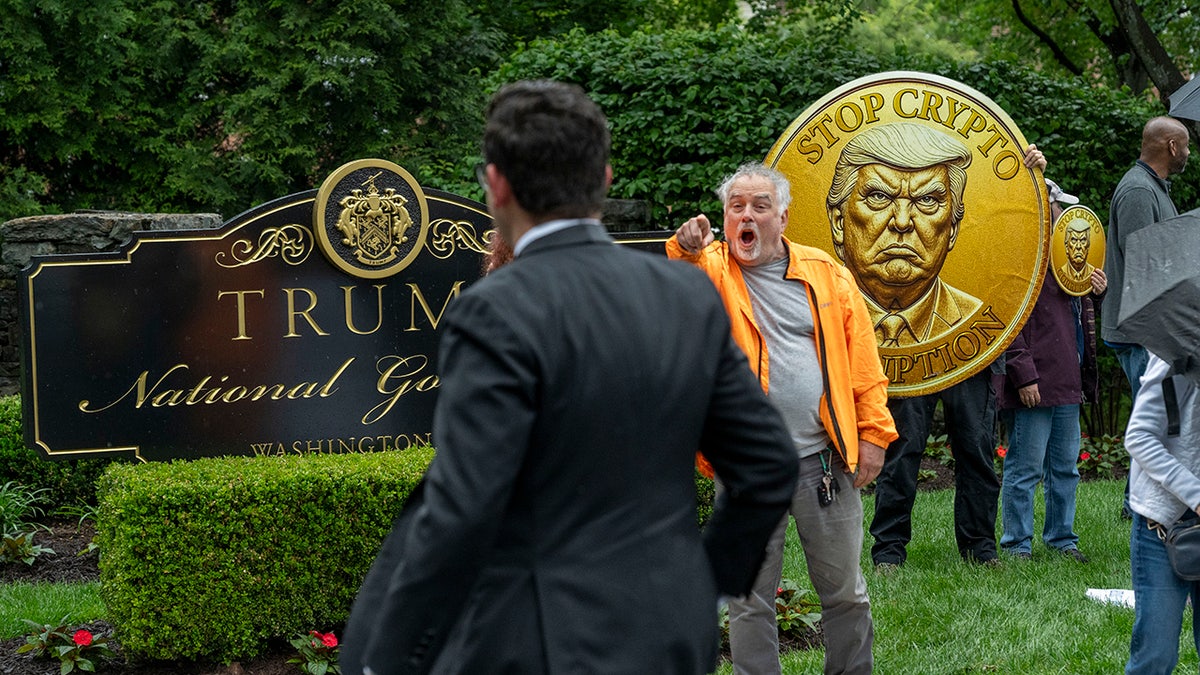 An activist calls out an attendee of an exclusive dinner at Trump National Golf Club Washington DC on Thursday, May 22. 
