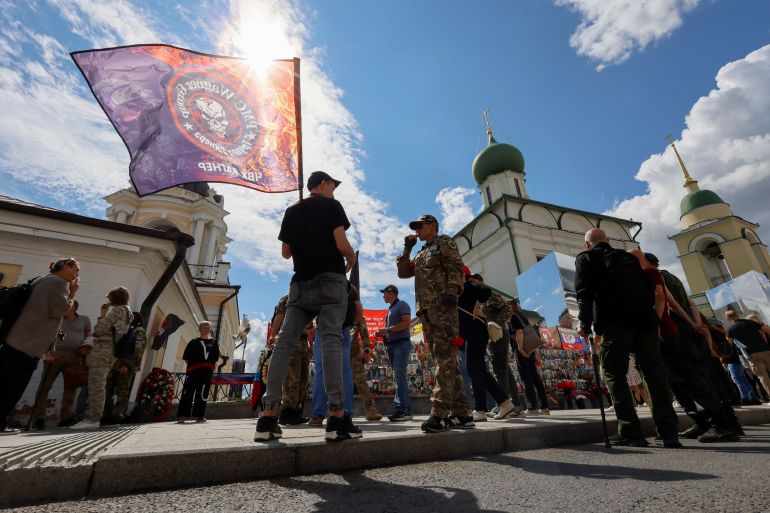 People gather near a makeshift memorial, which was erected following head of Russia's Wagner mercenary group Yevgeny Prigozhin and group commander Dmitry Utkin's death in 2023, during a commemoration ceremony held to pay tribute to Wagner fighters, who were recently killed in Mali by northern Tuareg rebels, in central Moscow, Russia August 4, 2024. REUTERS/Yulia Morozova