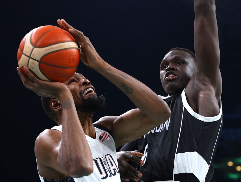 Paris 2024 Olympics - Basketball - Men's Group Phase - Group C - United States vs South Sudan - Lille, Pierre Mauroy Stadium, Villeneve-d'Ascq, France - July 31, 2024. Kevin Durant of United States in action with Khaman Maluach of South Sudan REUTERS/Brian Snyder