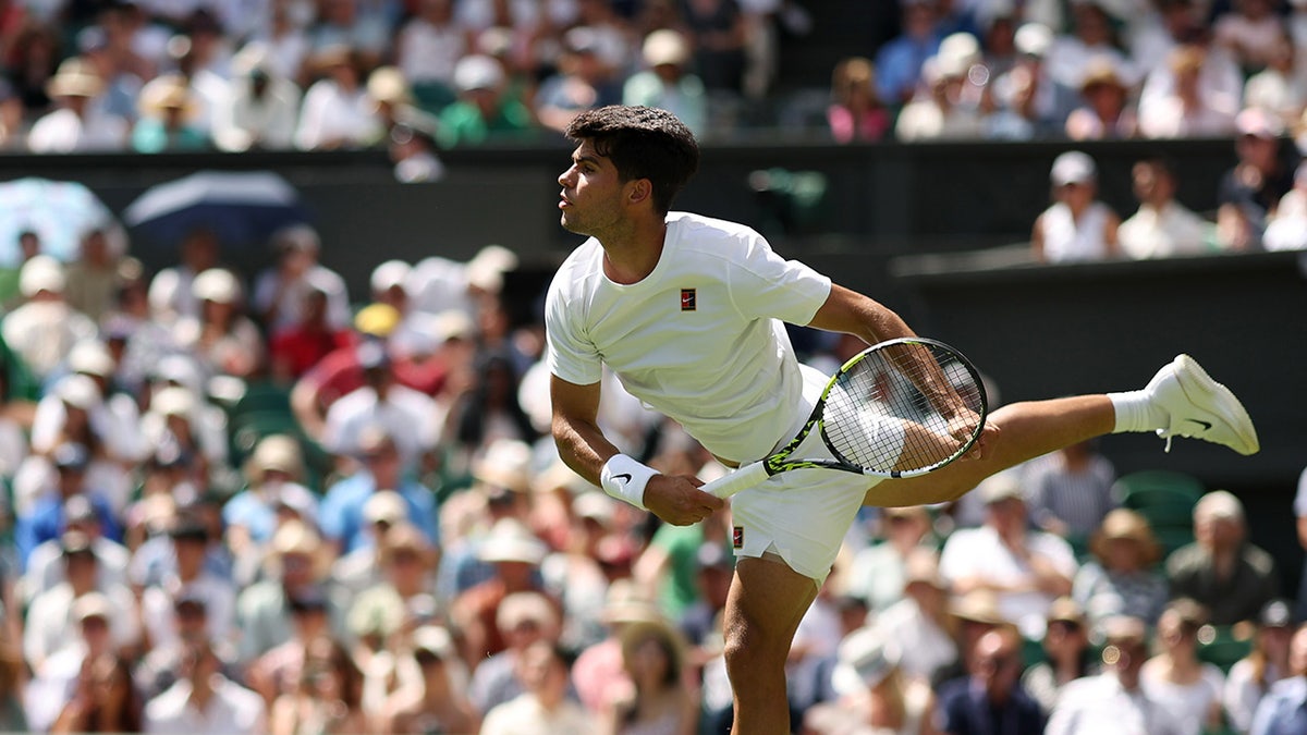 Carlos Alcaraz serves