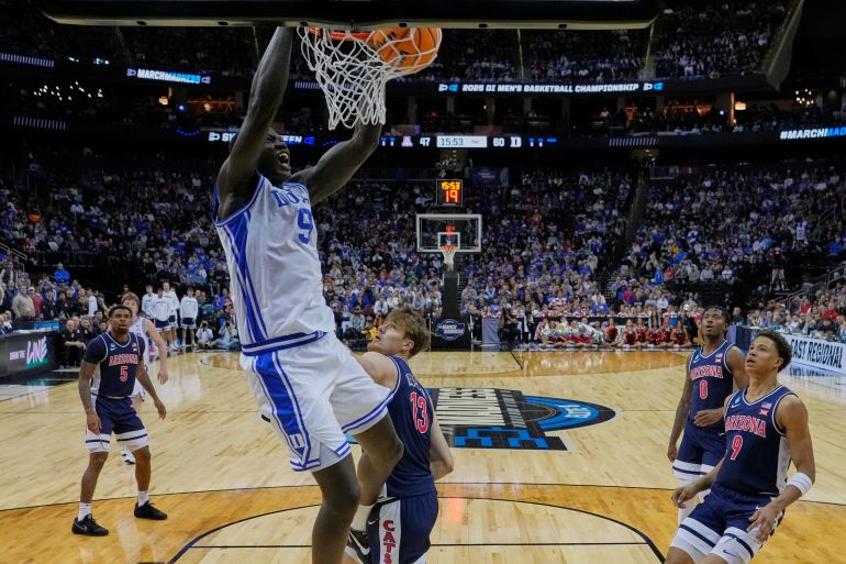 Duke 's Khaman Maluach (9) dunks the ball in front of Arizona's Henri Veesaar (13) and Carter Bryant (9) during the second half of a Sweet 16 round NCAA college basketball tournament game Thursday, March 27, 2025, in New York. (AP Photo/Frank Franklin II)