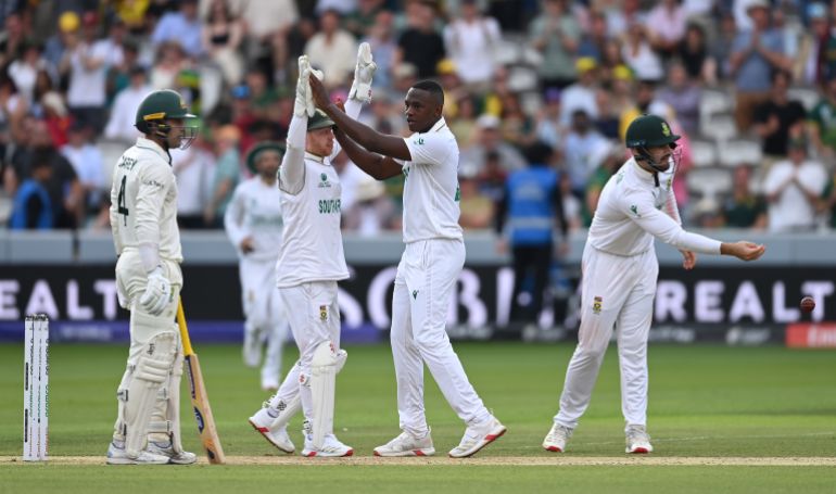 Kagiso Rabada of South Africa celebrates with team mate Kyle Verreynne after taking the wicket of Alex Carey of Australia during day two of the ICC World Test Championship Final 2025