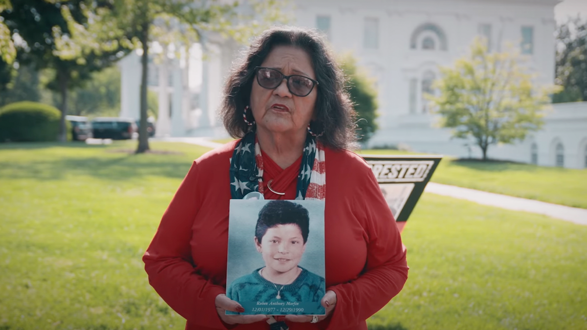 angel mom holding photo of son