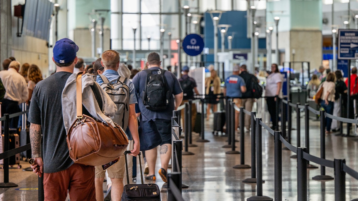 Passengers wait to pass through security at the Austin-Bergstrom International Airport in Austin, Texas