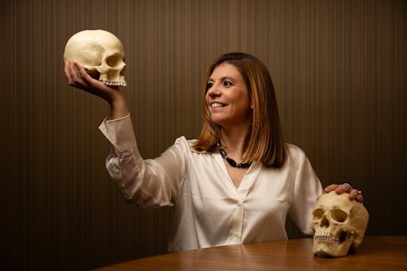 Dr Eline Schotsmans holding a replica of a Neolithic female human cranium.