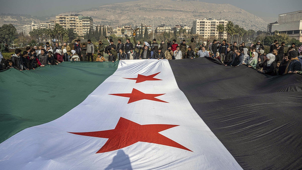 Syrians gather at Umayyad Square to celebrate the collapse of 61 years of Baath Party rule in Damascus, Syria on December 9, 2024.