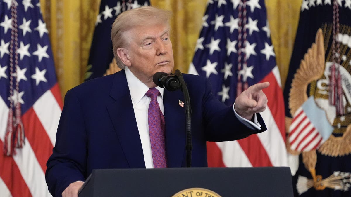 Trump at lectern, pointing